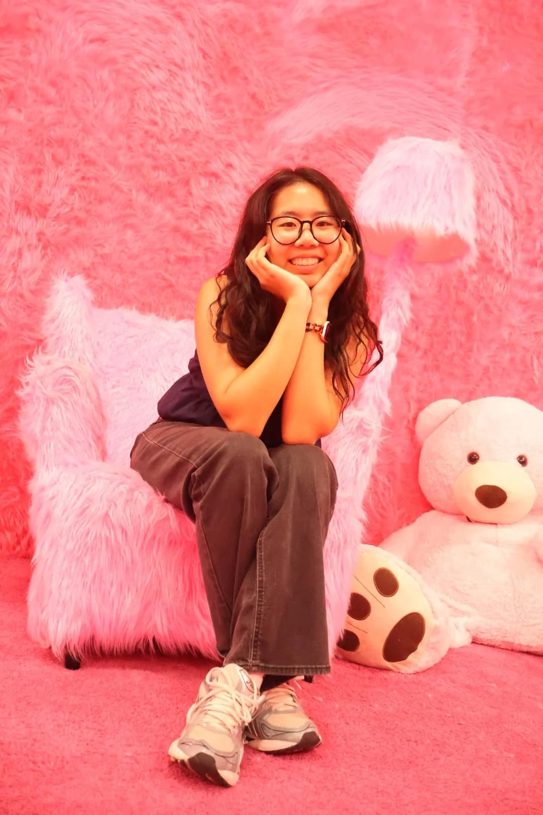 Sue sitting in a playful pink room