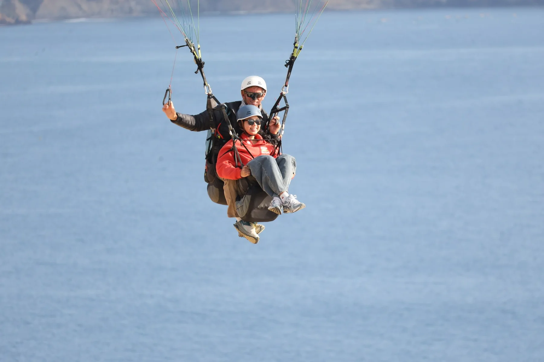 Sue paragliding above the coast