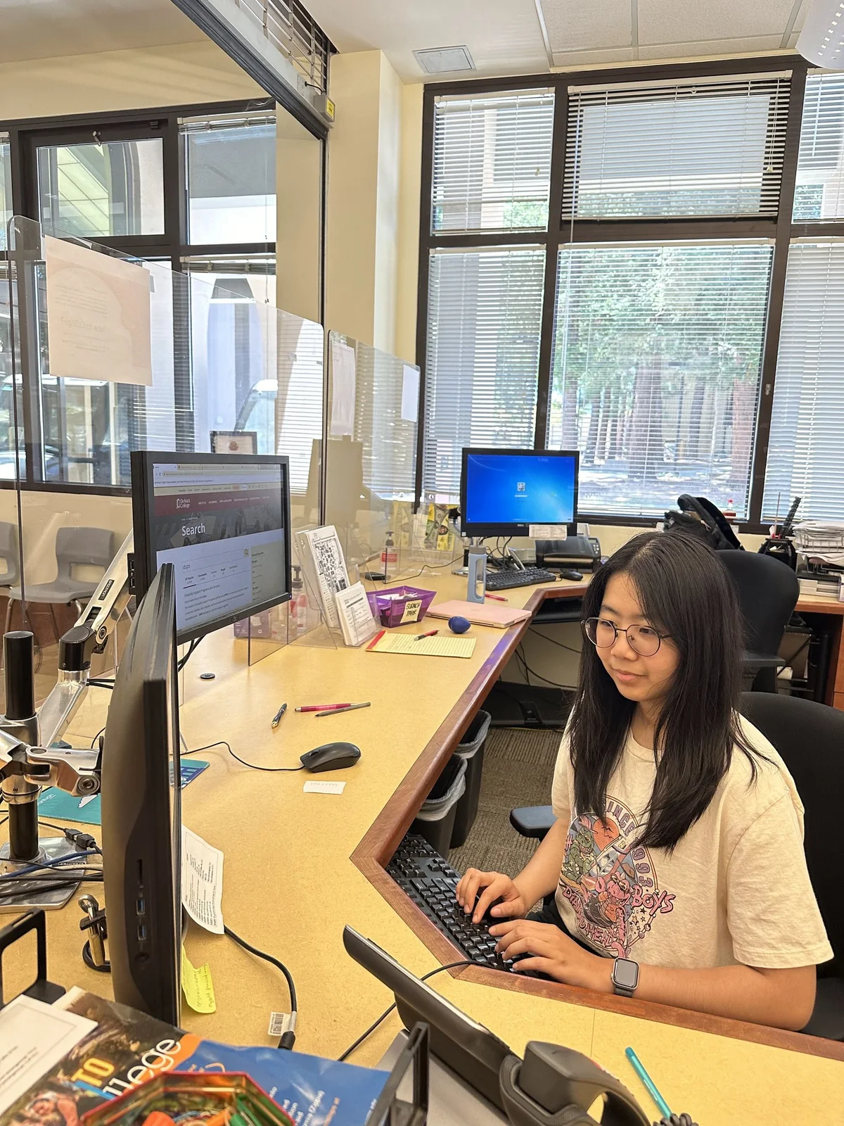 Sue working at the De Anza College front desk